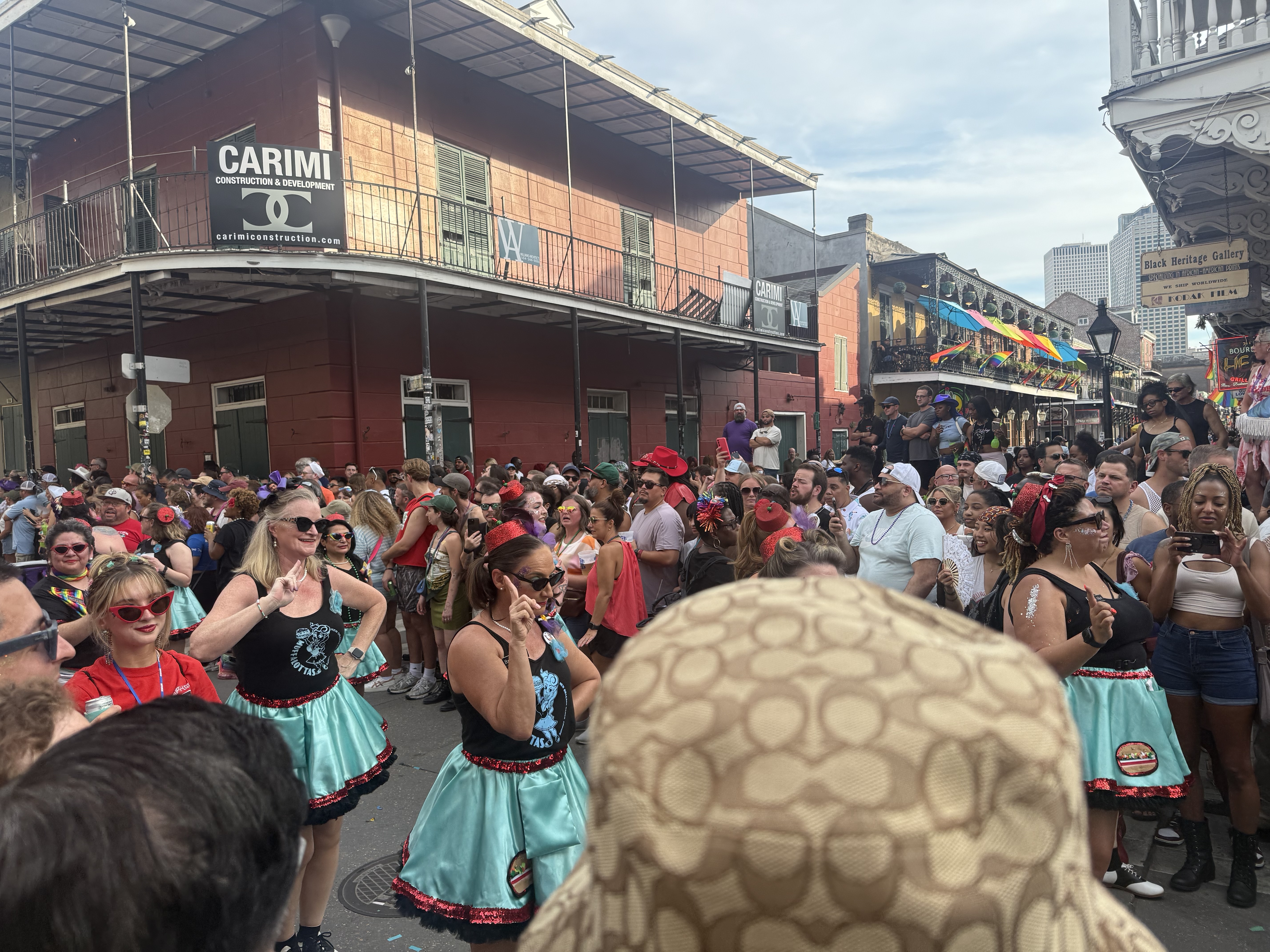 A colorful parade crowd in the New Orleans French Quarter